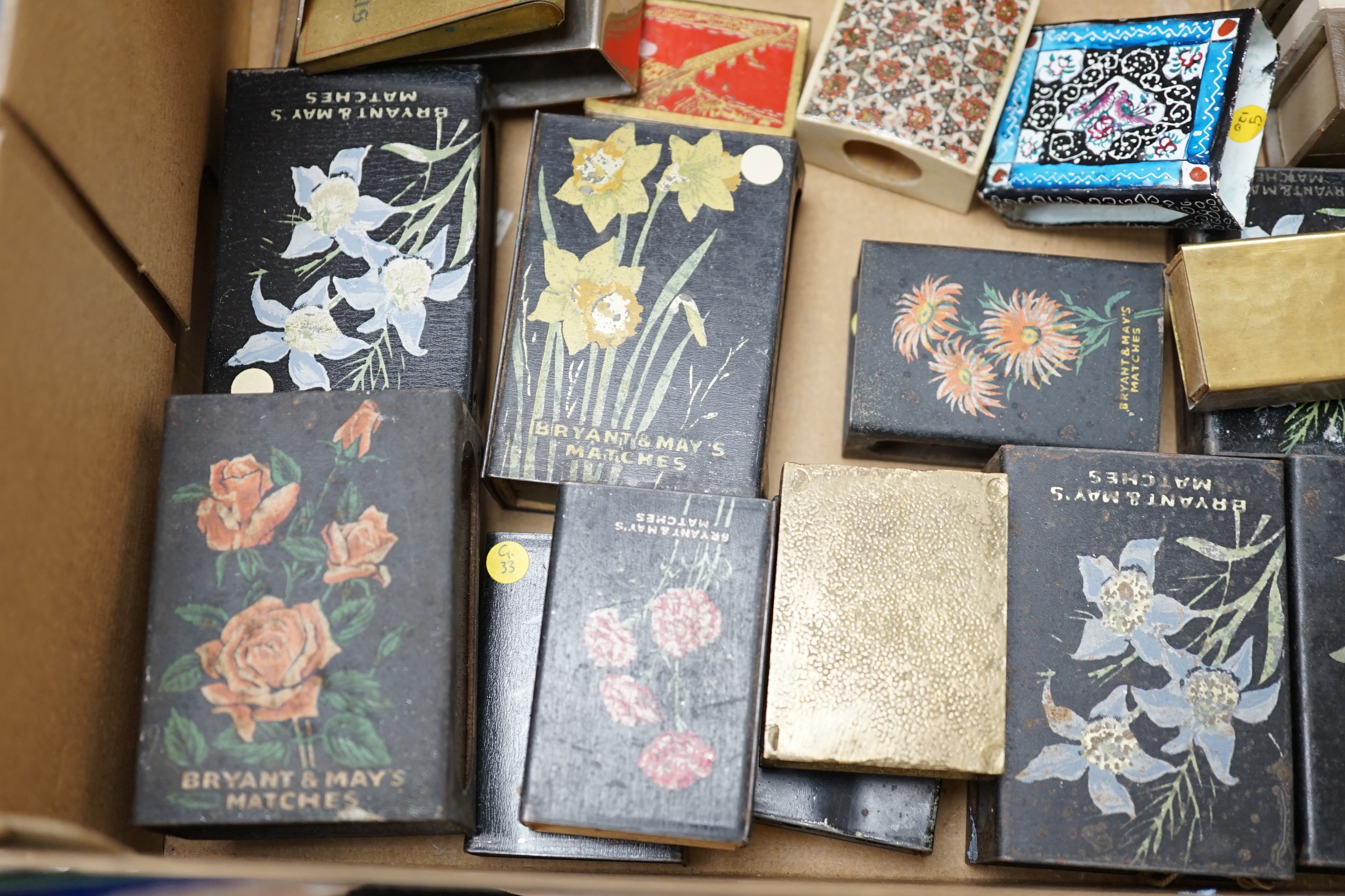 A collection of advertising and other enamelled metal match box holders